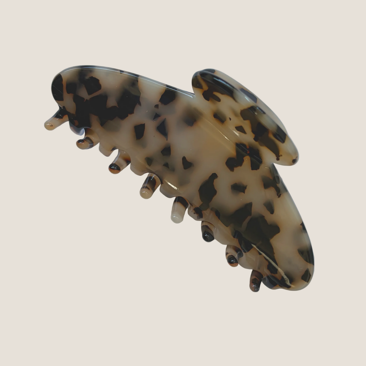 Tortoiseshell patterned hair clip on a white background