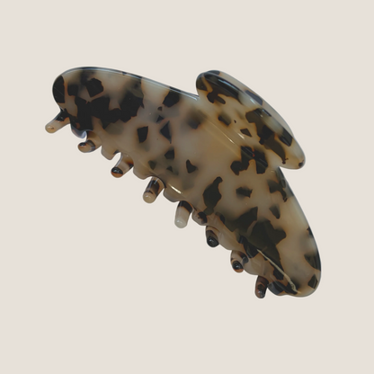 Tortoiseshell patterned hair clip on a white background