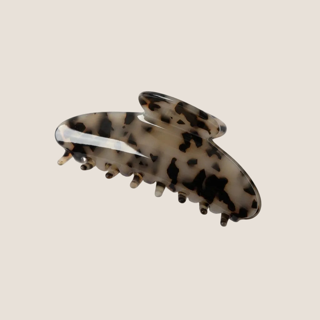 Tortoiseshell patterned hair clip on a white background