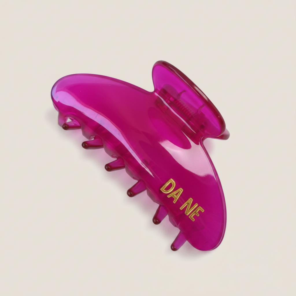 Pink hair claw with 'DA NE' branding on a white background