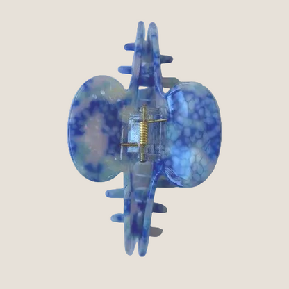 Blue and clear hair clip on a white background