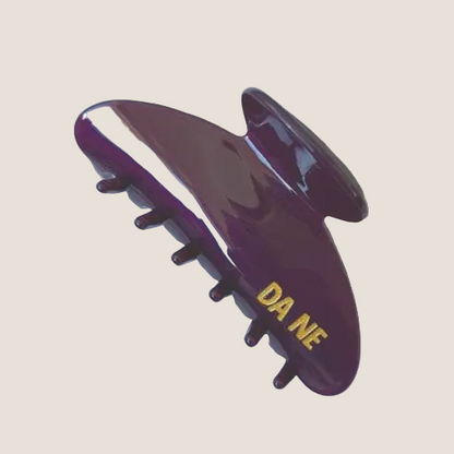 Purple claw with 'DA NE' branding on a white background