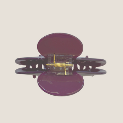 Purple hair clip with clear center on a white background